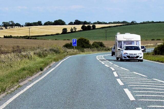 A white camper van driving along an A road in Lincolnshire