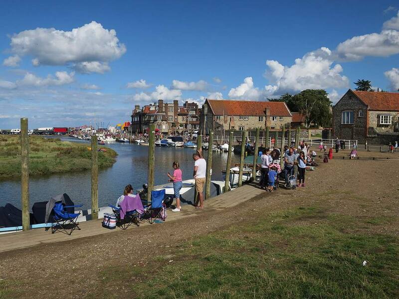 Families with crab lines and buckets along the quay at Blakeney