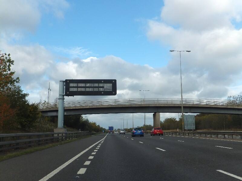An overhead information sign and a bridge over the M5 motorway