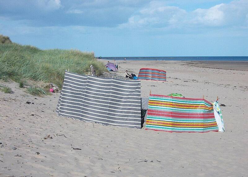 Two striped windbreaks on the sand at Alnmouth beach